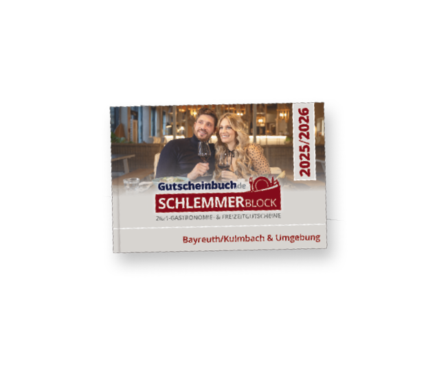 Served dinner table elegant arranged with Christmas decorations, rosemary wreath and gift box